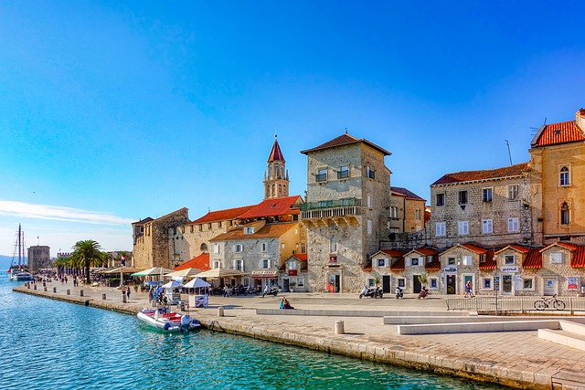 Trogir historic waterfront with medieval stone architecture and bell tower overlooking Adriatic Sea — UNESCO heritage site